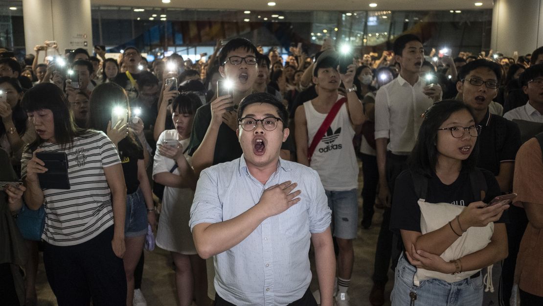 Demonstrators chant slogans during a flash mob at the International Finance Center (IFC) Mall in Hong Kong on Thursday, September 12, 2019. 