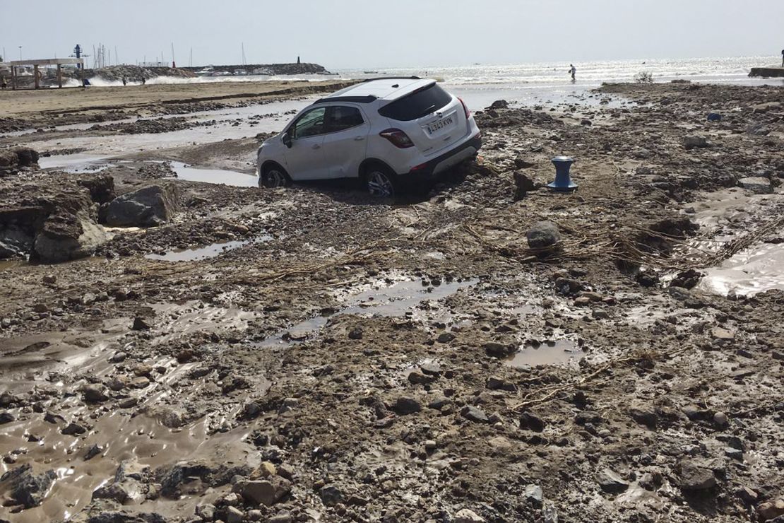 A car lies in the mud after a flood in San Jose, Almeria, in south-eastern Spain on Friday.