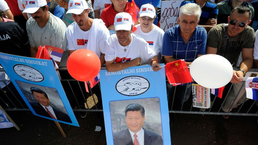 Workers at the Zelezara Smederevo steel plant, recently bought by China's Hebei Iron and Steel (HBIS), hold posters depicting China's President Xi Jinping, during Xi Jinping's tour of the plant in Smederevo, on June 19, 2016. Chinese President Xi Jinping on June 18 backed Serbia's bid to join the European Union during a visit to the country which aims to become a hub for Chinese imports into southeast Europe. Xi's visit comes two months after China's HBIS, the world's third-biggest steel producer, bought Serbia's sole steel mill and largest exporter Zelezara Smederevo for 46 million euros ($52 million).  / AFP / STR / OLIVER BUNIC        (Photo credit should read OLIVER BUNIC/AFP/Getty Images)