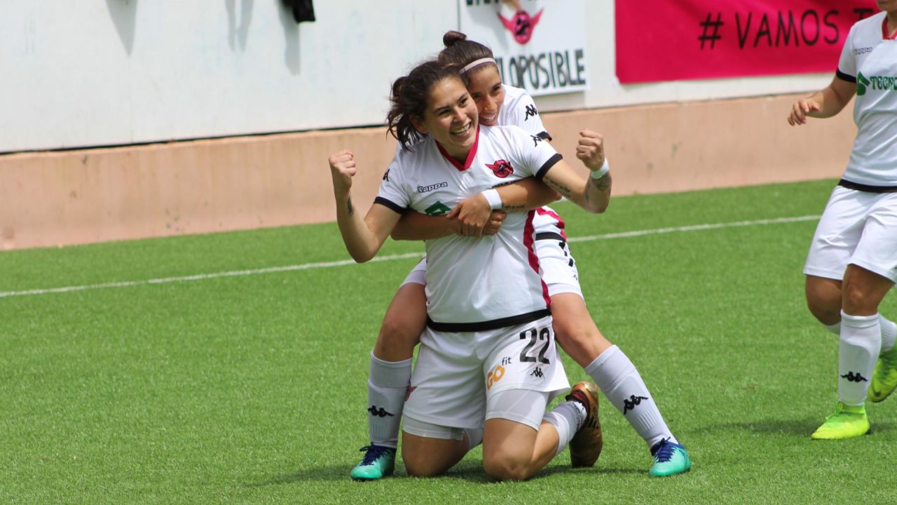 Two CD Tacon players celebrate after scoring a goal.
