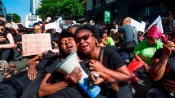 Women cry in front of the Johannesburg Stock Exchange in Johannesburg on September 13, 2019, during a protest against the abuse of women. - The murder of Uyinene Mrwetyana, a 19 year-old university student that was raped and killed on August 24, in Cape Town has caused a groundswell of anger and protest against violence against women in South Africa. (Photo by GUILLEM SARTORIO / AFP)        (Photo credit should read GUILLEM SARTORIO/AFP/Getty Images)