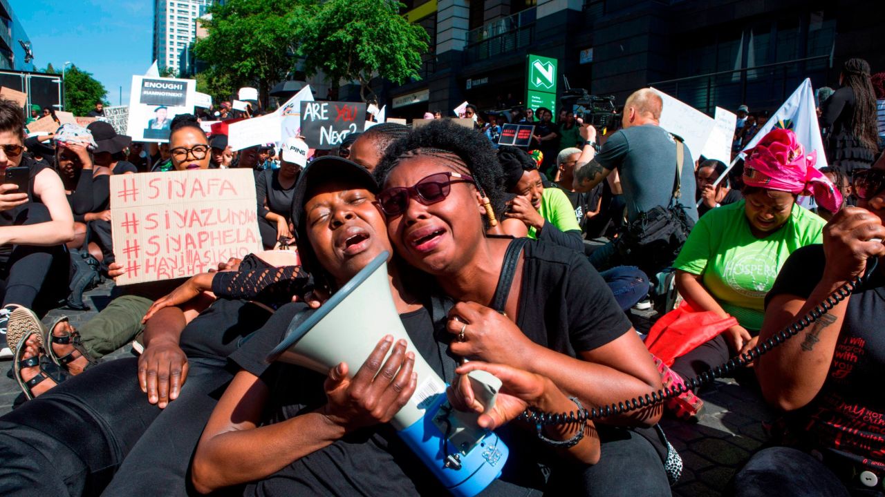 Women cry in front of the Johannesburg Stock Exchange on September 13, 2019, during a protest against the abuse of women in South Africa.