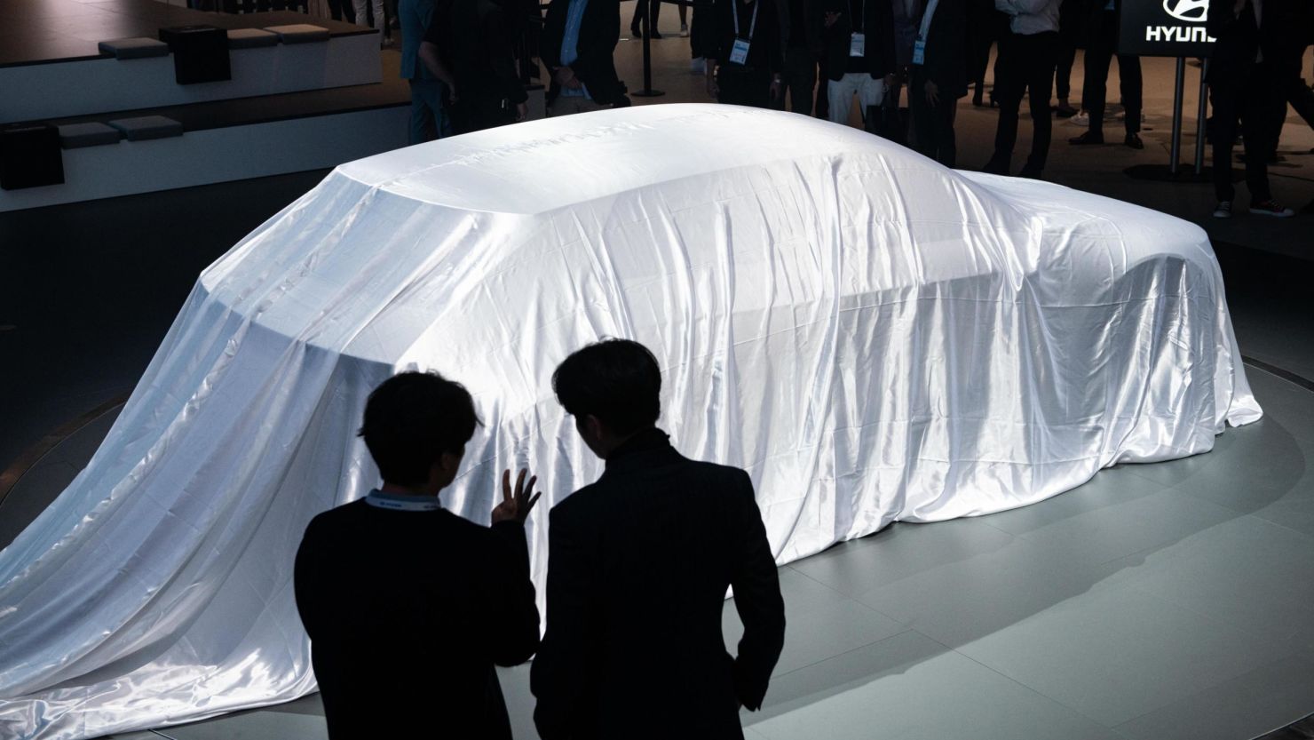 FRANKFURT AM MAIN, GERMANY - SEPTEMBER 10: Spectators wait for the unveiling of a Hyundai concept car at the Frankfurt Motor Show. (Photo by Thomas Lohnes/Getty Images for Hyundai)