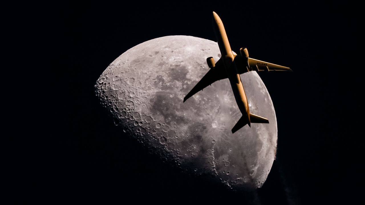 <strong>Moon crossing</strong>: He took this photograph of a Singapore Airlines Boeing 777 in front of the moon as the plane passed over Brisbane. 
