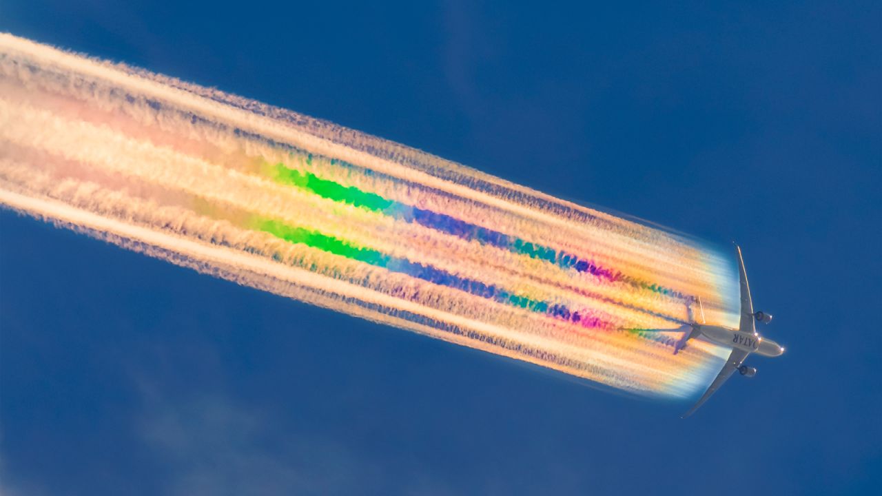 <strong>Rainbow marvel: </strong>Australian photographer Michael Marston took this stunning shot of a Qatar Airways Boeing 777 with dramatic rainbow contrails flying over Brisbane, Australia. 