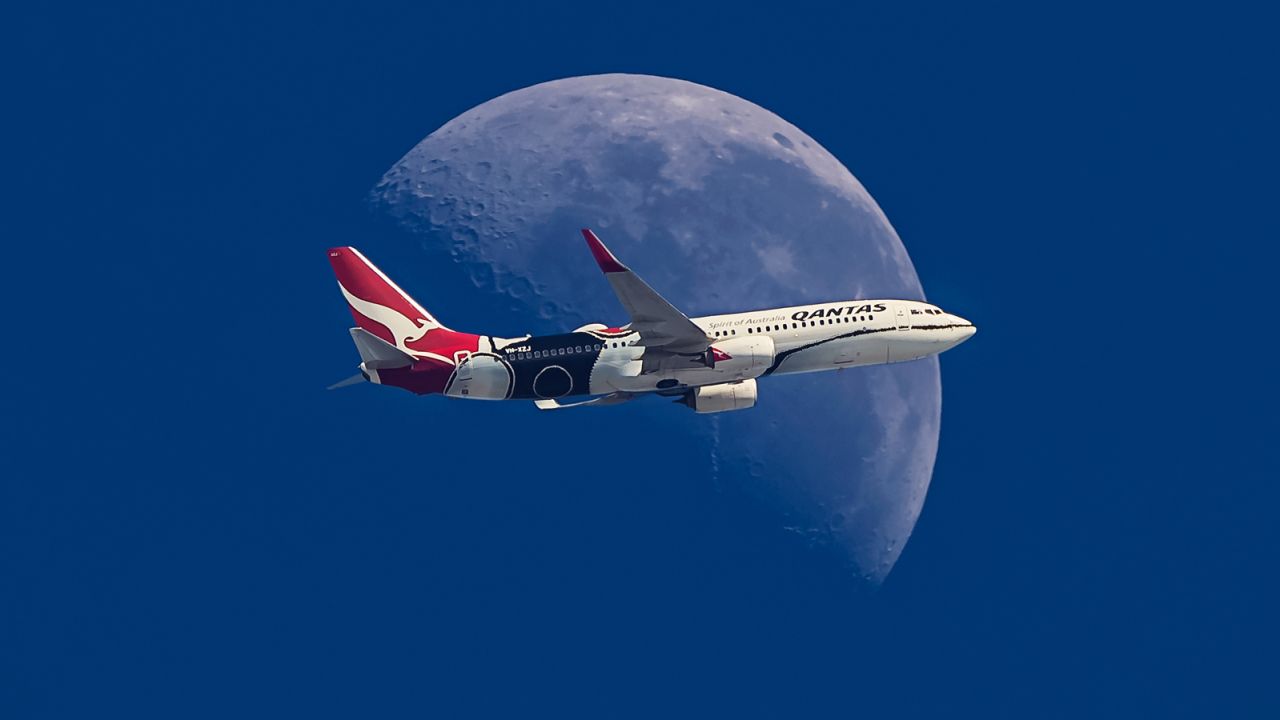 Marston took this photograph of a Qantas Boeing 737 crossing the moon. His partner, Tracy, is a Qantas flight attendant and she was on board.