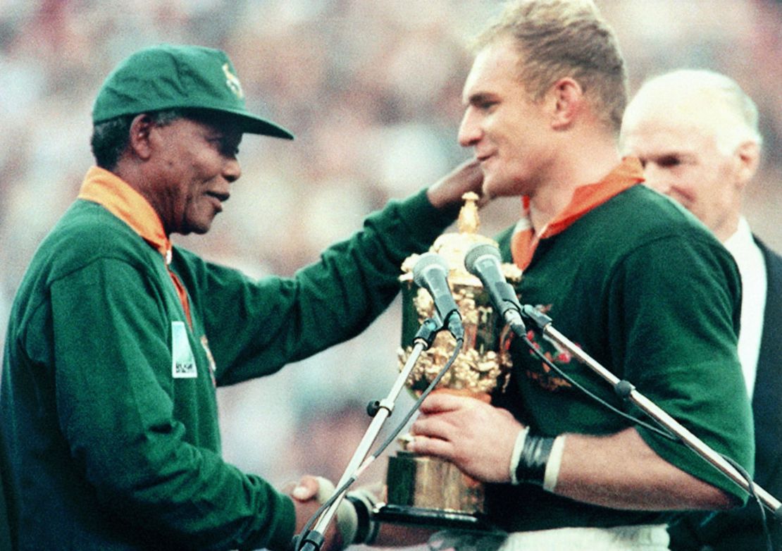 Nelson Mandela hands Francois Pienaar the Webb Ellis Cup after the Springboks beat the New Zealand All Blacks in the 1995 Rugby World Cup