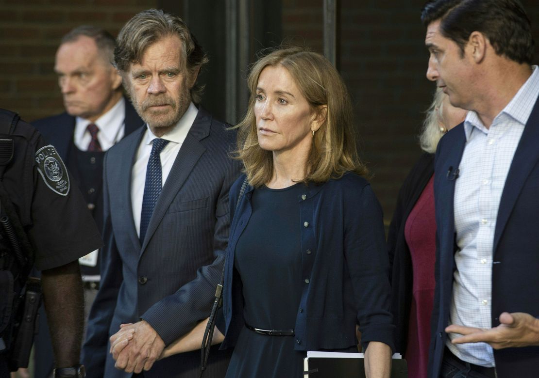 Actress Felicity Huffman, escorted by her husband William H. Macy, exits the US courthouse in Boston, after her sentencing on September 13, 2019.