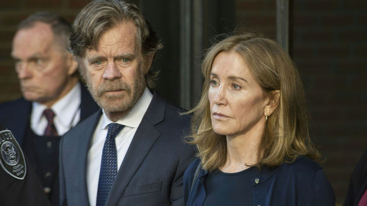 Actress Felicity Huffman, escorted by her husband William H. Macy, exits the US courthouse in Boston, after her sentencing on September 13, 2019.