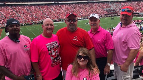 Dwight Standridge, second from left, and other UGA fans wear pink to support in support of Arkansas State coach Blake Anderson, who lost his wife to cancer last month.