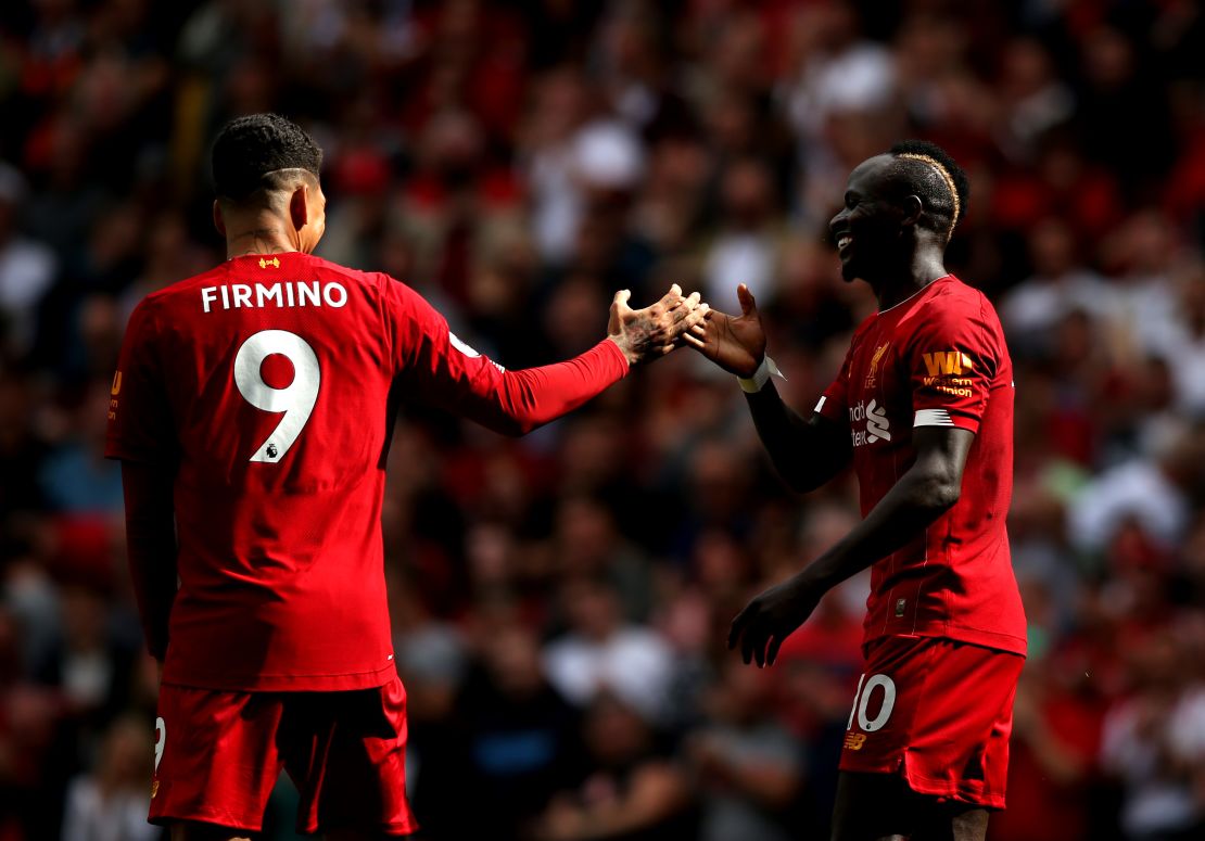 Sadio Mane and Roberto Firmino celebrate Liverpool's second goal.