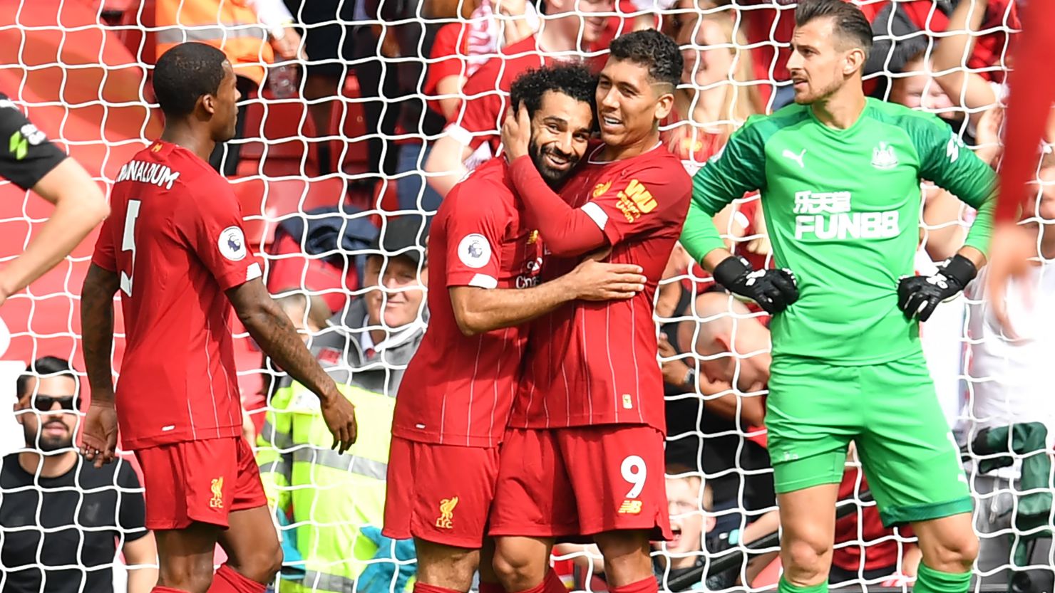 Mohamed Salah and Roberto Firmino celebrate Liverpool's third goal.