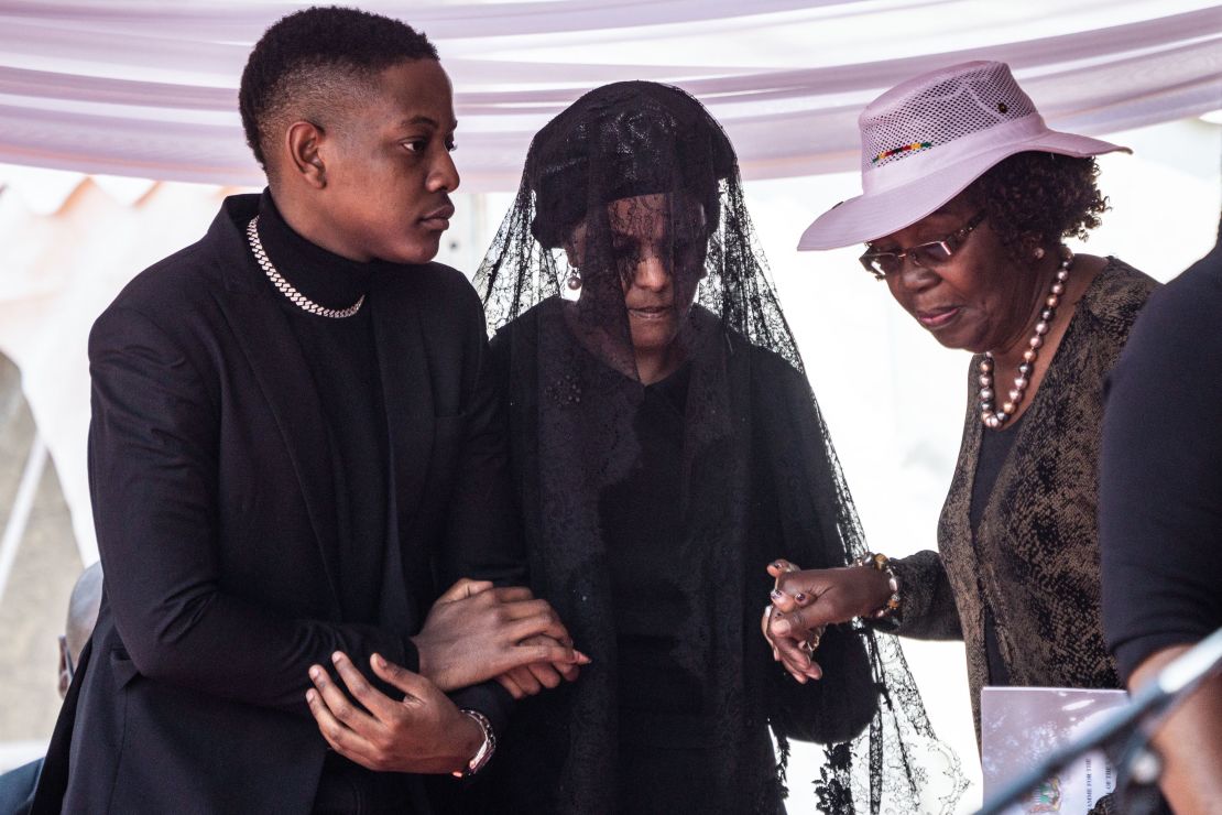 Zimbabwe's former first lady Grace Mugabe, center, attends the official farewell ceremony for her late husband Robert Mugabe.