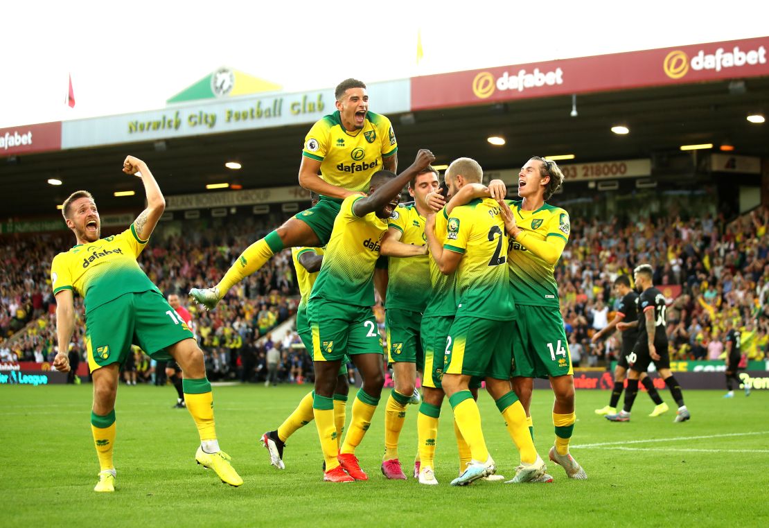 Teemu Pukki of Norwich City celebrates with teammates after scoring his team's third goal during the Premier League match between Norwich City and Manchester City at Carrow Road on September 14, 2019.