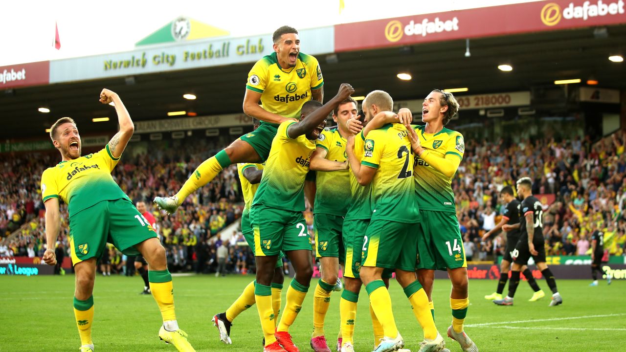 Teemu Pukki of Norwich City celebrates with teammates after scoring his team's third goal during the Premier League match between Norwich City and Manchester City at Carrow Road on September 14, 2019.