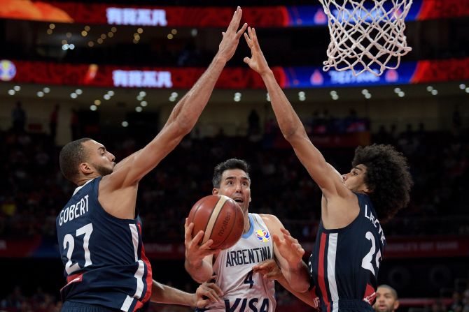 Argentina's Luis Scola is defended by French players Rudy Gobert and Louis Labeyrie during a World Cup semifinal game on Friday, September 13. 