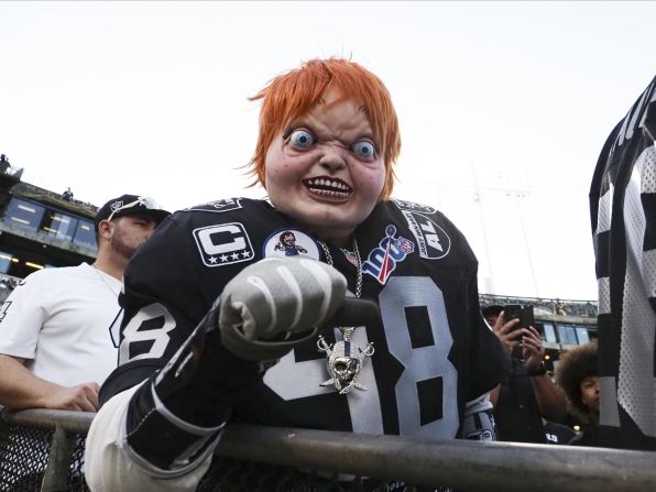 An Oakland Raiders fan wears a Chucky mask before the season opener against Denver on Monday, September 9. Oakland head coach Jon Gruden got the nickname Chucky because of his resemblance to the evil doll from the "Child's Play" horror films.