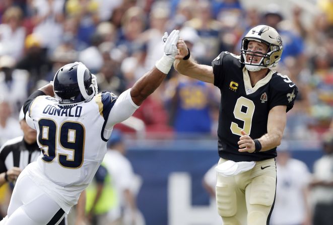 New Orleans quarterback Drew Brees injures his throwing hand while throwing a pass during an NFL game in Los Angeles on Sunday, September 15. He couldn't continue playing.