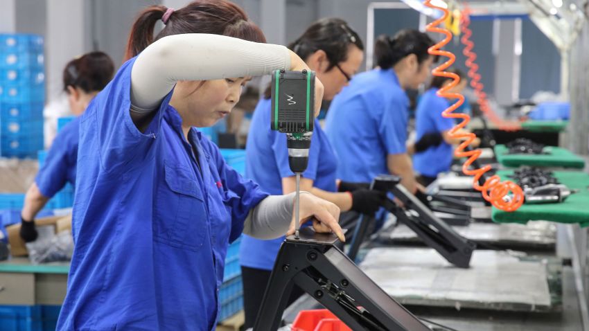 Workers produce desks for export to the US, France, Germany and other countries, at a factory in Nantong in China's eastern Jiangsu province on September 4, 2019. China said on September 2 it had lodged a complaint against the United States with the World Trade Organization (WTO), one day after new tariffs imposed by Washington on billions of dollars worth of Chinese goods came into force