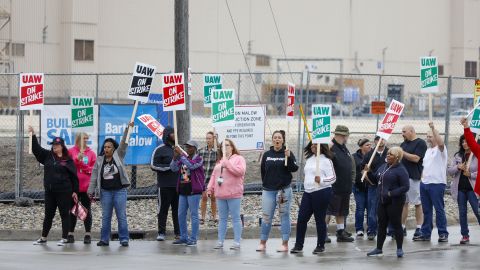 Workers picket at a gate at the General Motors Flint Assembly Plant in Flint, Michigan.