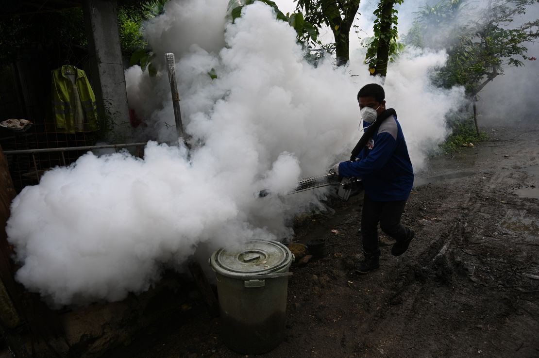 A municipal employee operates a fogging machine to kill mosquito larvae to fight the spread of dengue at a village in the town of Antipolo, Rizal province, east of Manila.