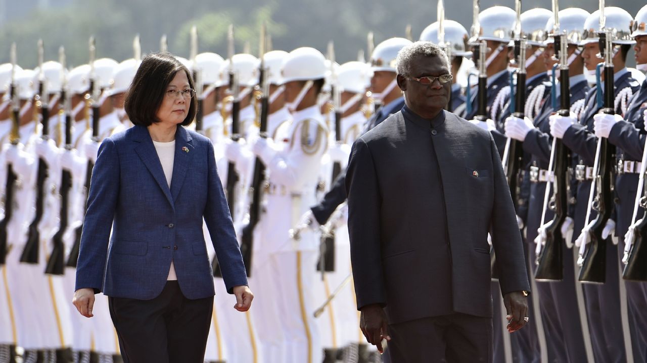 Solomon Islands President Manasseh Sogavare (R) and Taiwan President Tsai Ing-wen (L) inspect an honour guard during a welcome ceremony in Taipei on September 26, 2017.