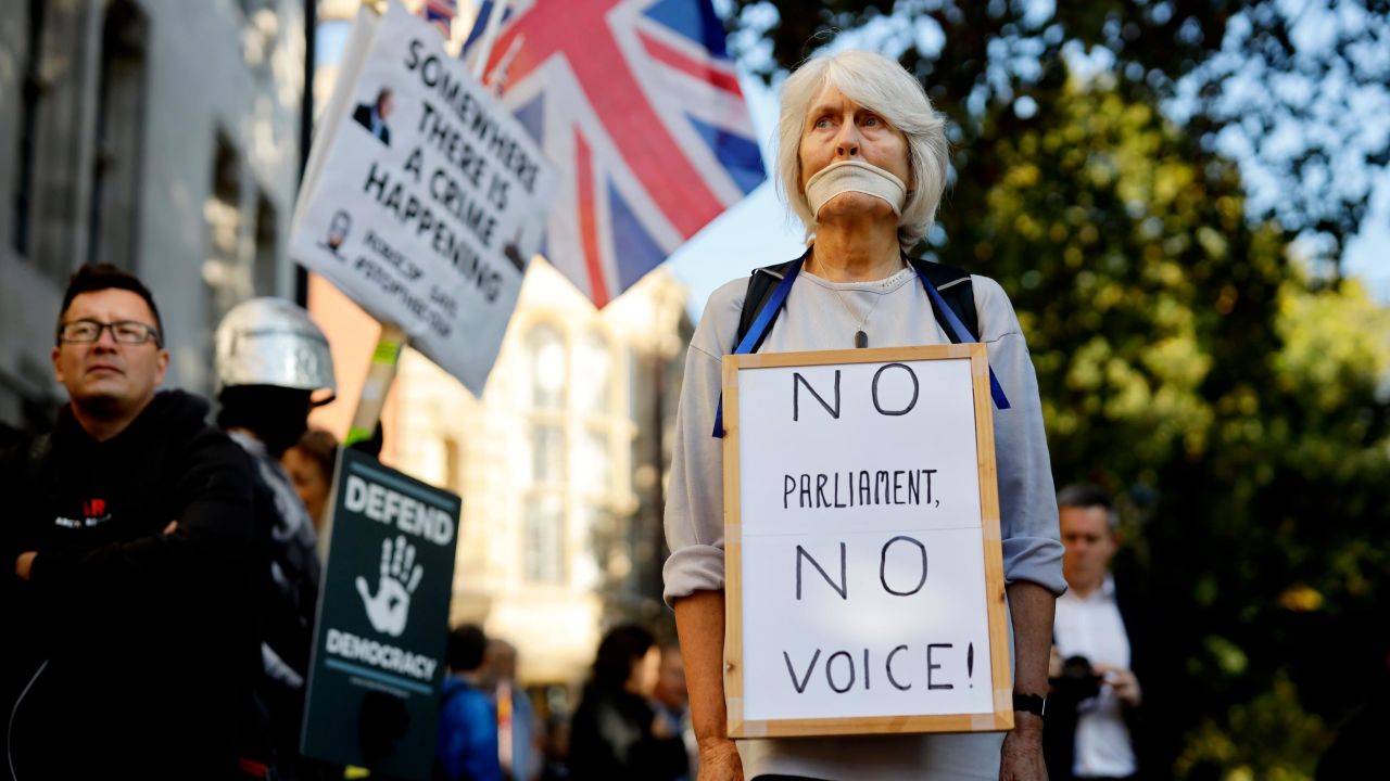 A woman protests outside the Supreme Court in central London on the first day of the hearing into the decision by the UK Government to prorogue Parliament.