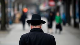 A Jewish man crosses a street in a Jewish quarter in Williamsburg, Brooklyn, on April 9, 2019 in New York City.