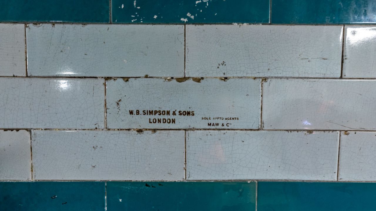 <strong>Intricate details: </strong>This tiled wall in a disused section at Piccadilly Circus station is stamped with the supplier's mark of W.B. Simpson & Sons, London, and made by Maw and Company.