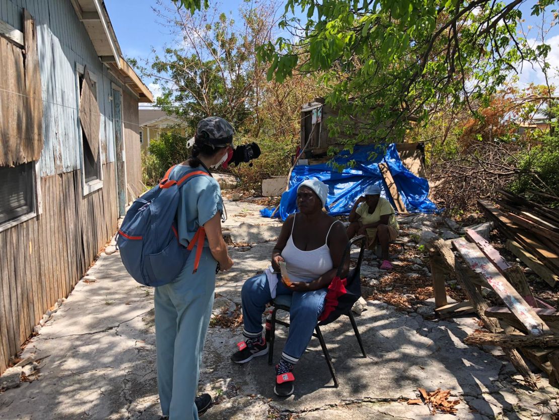 A volunteer medic speaks to a hurricane survivor on battered Grand Bahama Island. 