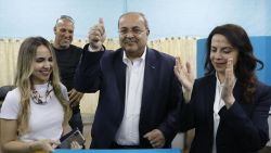 Israeli Arab politician Ahmed Tibi stands between his daughter (L) and wife as he casts his vote during Israel's parliamentary elections on April 9, 2019 in in the northern Israeli town of Taiyiba. - Israelis voted today in a high-stakes election that will decide whether to extend Prime Minister Benjamin Netanyahu's long right-wing tenure despite corruption allegations or to replace him with an ex-military chief new to politics. (Photo by Ahmad GHARABLI / AFP)        (Photo credit should read AHMAD GHARABLI/AFP/Getty Images)