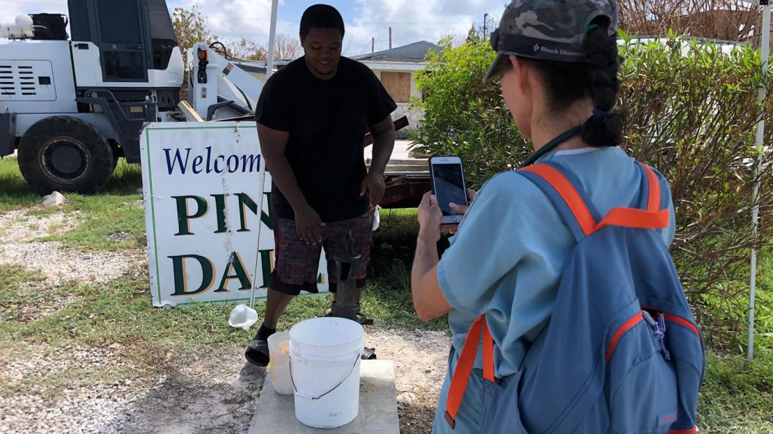 Medic Andrea Krasniansky speaks with a resident on Grand Bahama Island. He said the local well water is no longer safe for drinking because it's contaminated.