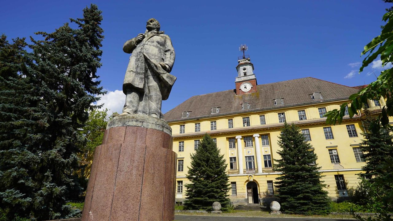 A statue of Lenin keeps guard at the entrance of the former military complex.