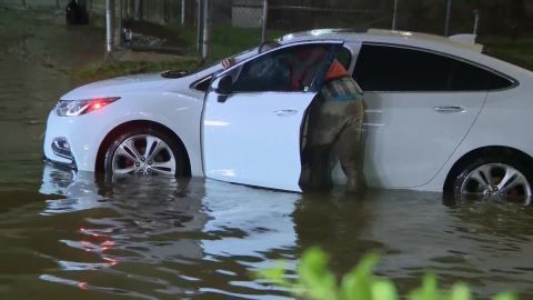A stalled car sits on a flooded road near Houston's William P. Hobby Airport early Wednesday.