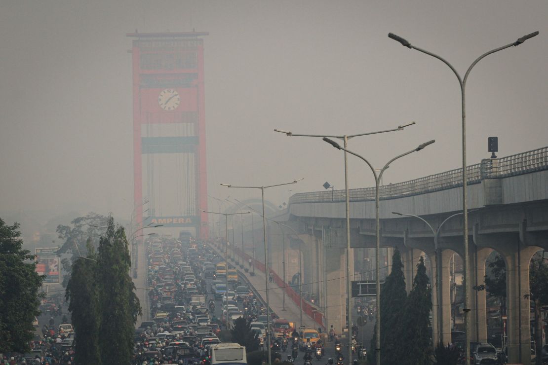 Motorists commute on a hazy day in Palembang on September 18, 2019. 