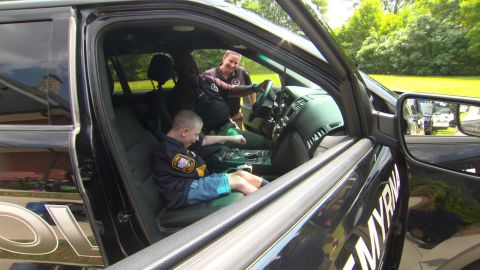 Tye Clinner checks out a police vehicle at his surprise party.