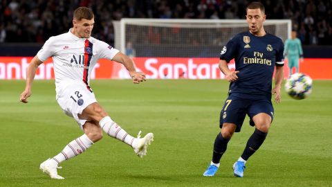 Paris Saint-Germain defender Thomas Meunier (L) challenges Real Madrid's Eden Hazard.