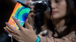 19 September 2019, Bavaria, Munich: A woman photographs the Huawei Mate 30 Pro smartphone after a Huawei press conference. Huwaii has introduced the new smartphone series Mate 30 / 30 Pro. Photo: Sven Hoppe/dpa (Photo by Sven Hoppe/picture alliance via Getty Images)