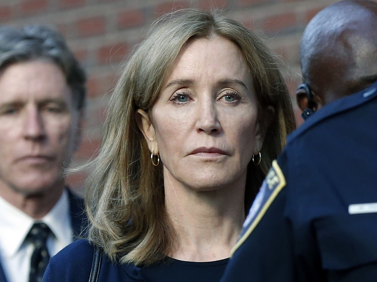 Felicity Huffman leaves federal court after she was sentenced to <a href="https://www.cnn.com/2019/09/13/us/felicity-huffman-sentencing/index.html" target="_blank">14 days in prison</a> following a nationwide college admissions bribery scandal, on Friday, September 13, in Boston. The "Desperate Housewives" actress also will have to serve a year of probation, perform 250 hours of community service and pay a $30,000 fine.