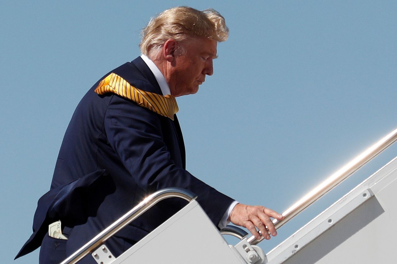 Money sticks out of the back pocket of US President Donald Trump as he boards Air Force One at Moffett Federal Airfield in Mountain View, California, on Tuesday, September 17.  
