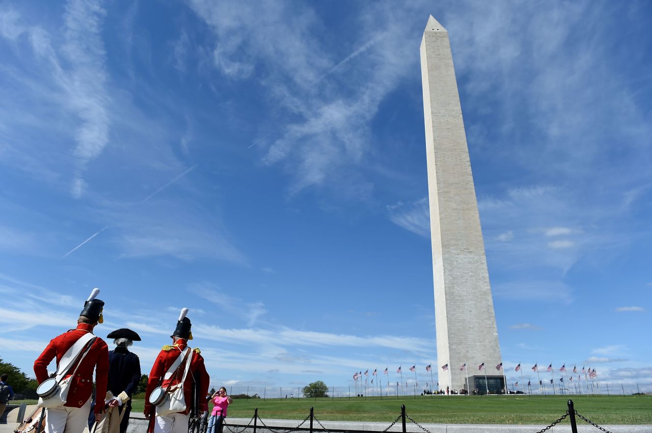 People dressed in historical costumes participate in the <a href="https://www.cnn.com/travel/article/washington-monument-reopens-washington-dc-trnd/index.html" target="_blank">reopening of the Washington Monument</a> on the National Mall on Thursday, September 19, in Washington, DC.