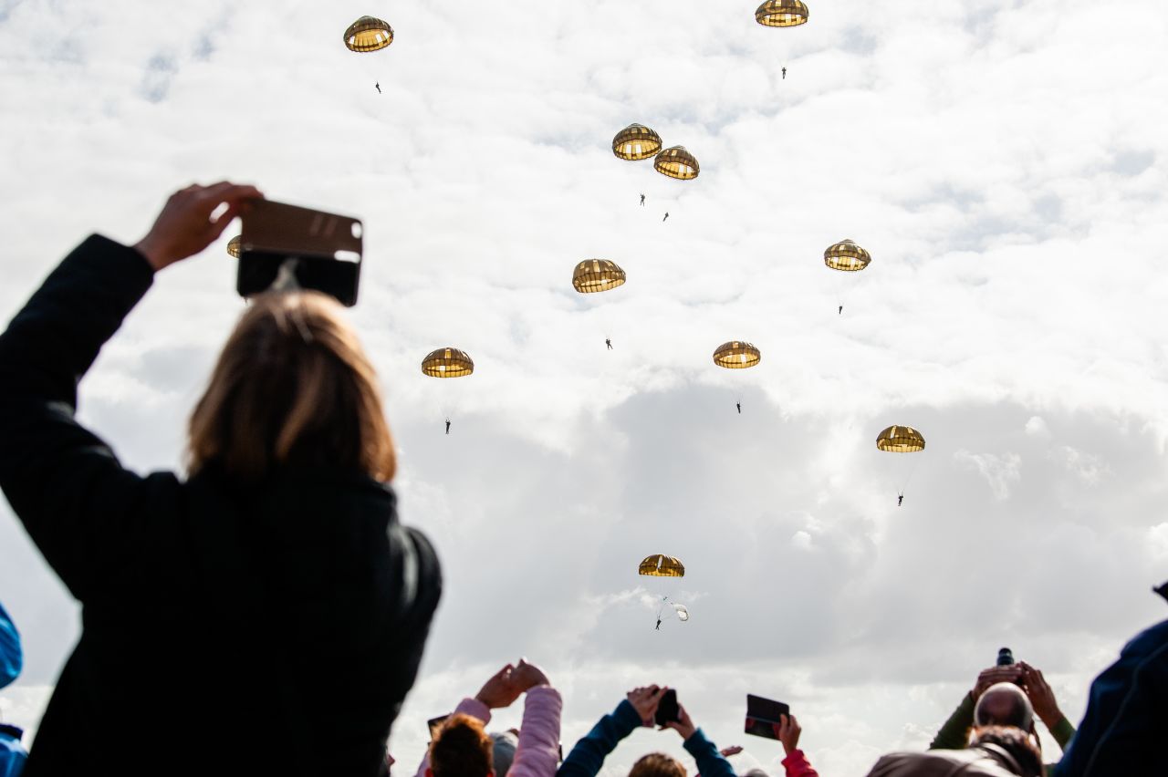 Spectators take photos of paratroopers descending on Wednesday, September 18 in Groesbeek, Gelderland, Netherlands. September marks 75 years since paratroopers from the 82nd Airborne Division landed in Groesbeek as part of the Operation Market Garden in World War II.