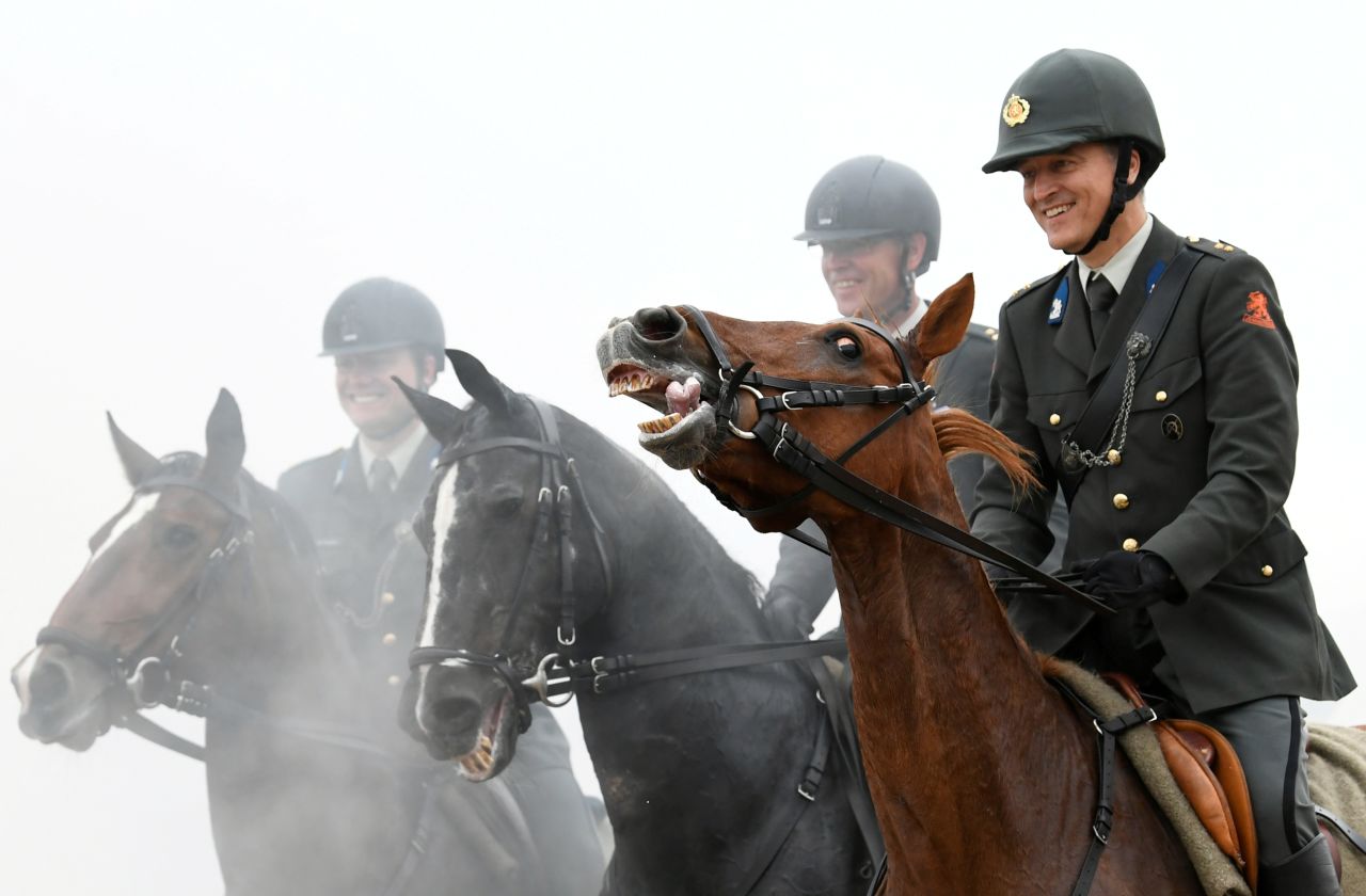 Members of the Dutch Royal Guard guide their horses through a cloud of thick smoke and gunfire on the beach of Scheveningen, near The Hague, in preparation of the presentation of the Dutch 2020 Budget Memorandum, in the Netherlands, on Monday, September 16.