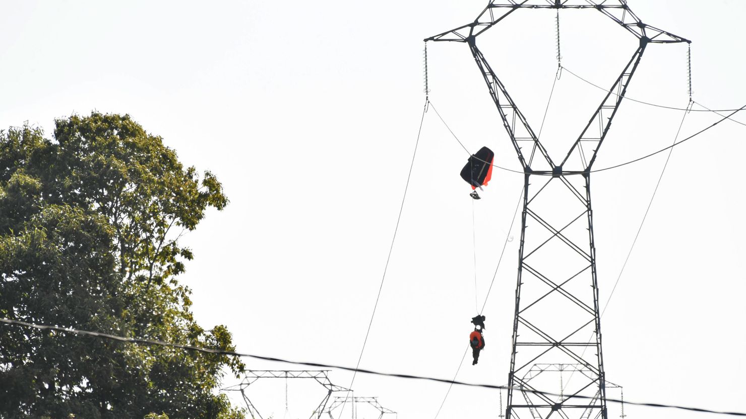 One pilot was caught on a high-voltage electricity line in north-western France before being rescued by emergency services.