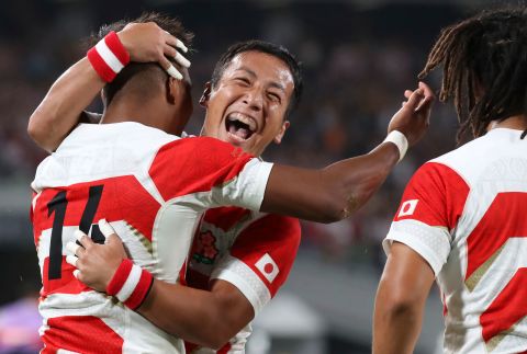 Japan's Matsushima, left, celebrates with Yutaka Nagare, center, after scoring one of his three tries.