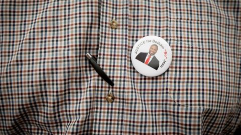 Botham Jean's pastor, Sammie Berry of Dallas West Church of Christ, wears a button supporting "Justice for Botham."
