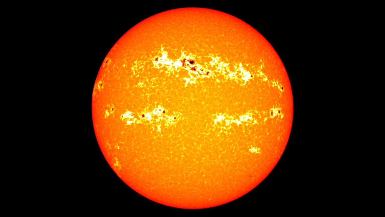 Sunspots appear like dark markings on the surface of the sun.