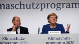 BERLIN, GERMANY - SEPTEMBER 20:  (L-R) German Finance Minister Olaf Scholz, German Chancellor Angela Merkel attend a press conference following a meeting of the "climate protection" government cabinet commission at the Futurium museum on September 20, 2019 in Berlin, Germany. The commission formulated a policy package on bringing down CO2 emissions in Germany. While Germany has made strong progress in expanding its renewable energy production over the last few decades, the government has come under criticism more recently for failing to do more to bring down greenhouse gas emissions. (Photo by Maja Hitij/Getty Images)