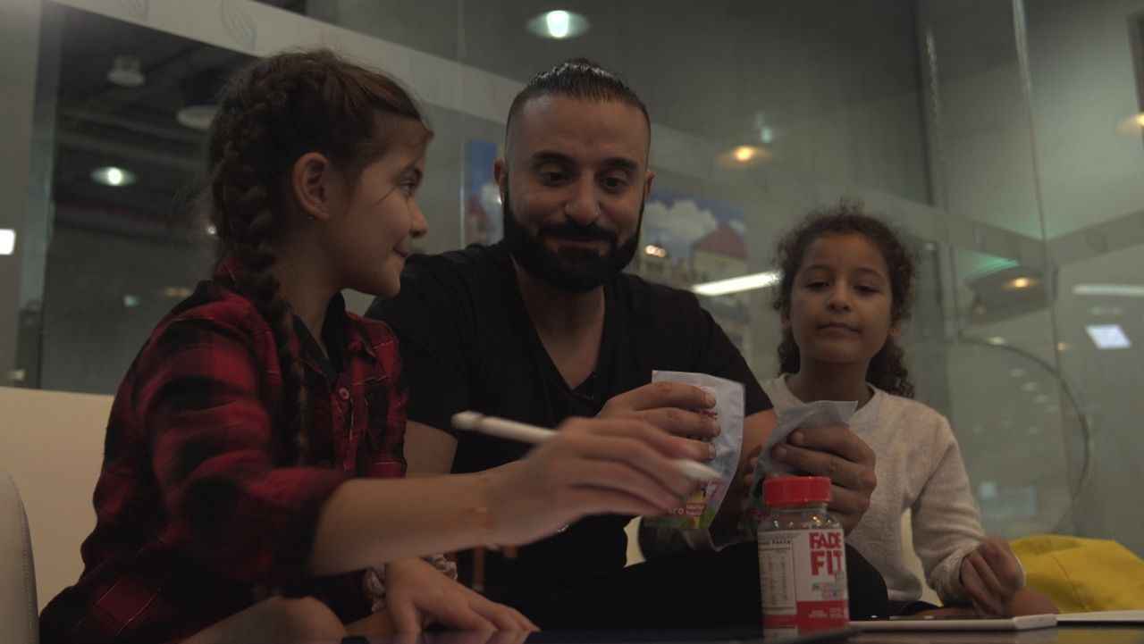 Fade involves his daughters in the taste-testing of the snacks his new start-up produces.