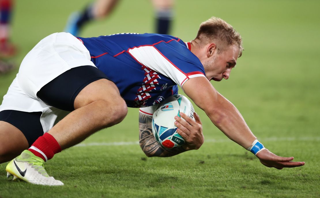 Kirill Golosnitskiy of Russia dives to score his side's first try during the Rugby World Cup.